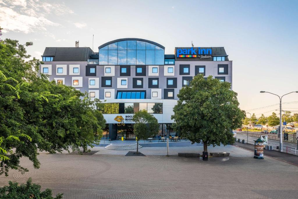 a large building with a sign on top of it at Park Inn by Radisson Danube Bratislava in Bratislava