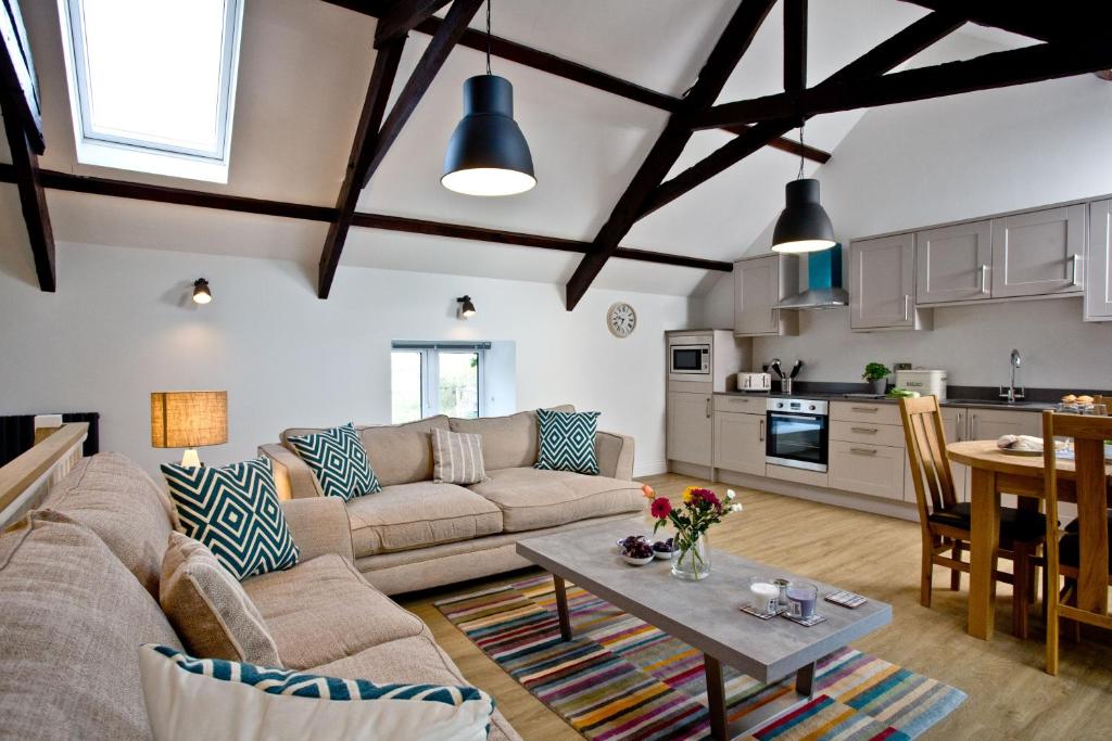 a living room with a couch and a table at The Barn, 21 At The Beach, Torcross in Beesands