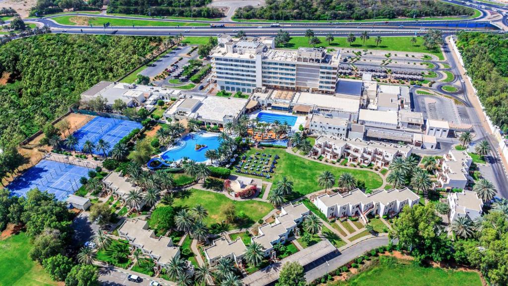 a city with a lot of green grass and trees at Radisson Blu Hotel & Resort, Al Ain in Al Ain