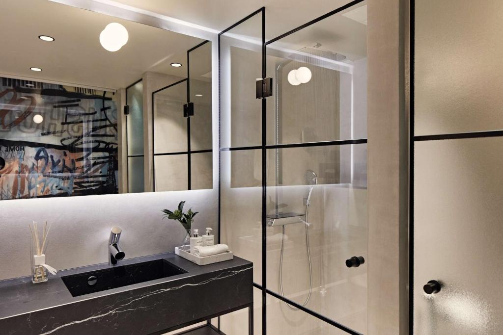 a bathroom with a glass shower and a sink at Radisson Blu Seaside Hotel, Helsinki in Helsinki