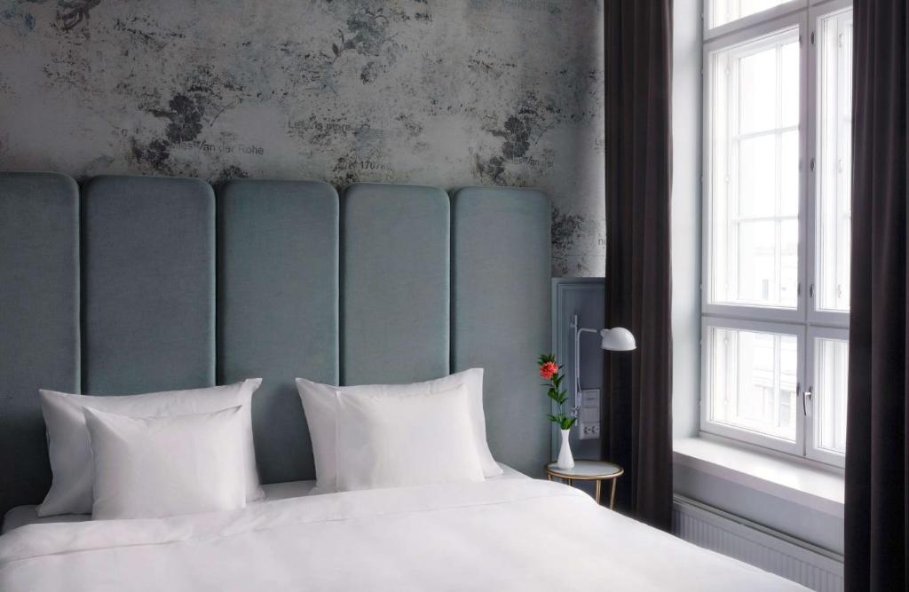 a bedroom with a large bed with white pillows at Radisson Blu Seaside Hotel, Helsinki in Helsinki