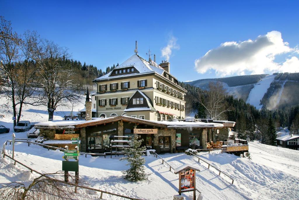 a large building in the snow on a mountain at Hotel Praha in Špindlerův Mlýn