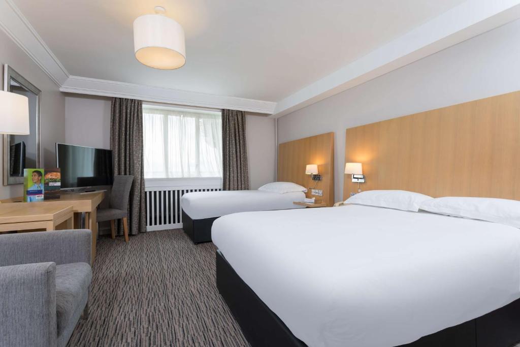 a hotel room with two beds and a television at Park Inn by Radisson Shannon Airport in Shannon