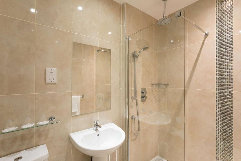 a bathroom with a shower and a sink and a toilet at Park Inn by Radisson Shannon Airport in Shannon