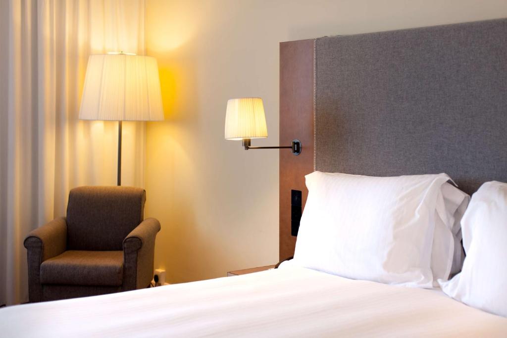 a hotel room with a bed and a chair at Radisson Blu Waterfront Hotel, Jersey in Saint Helier Jersey