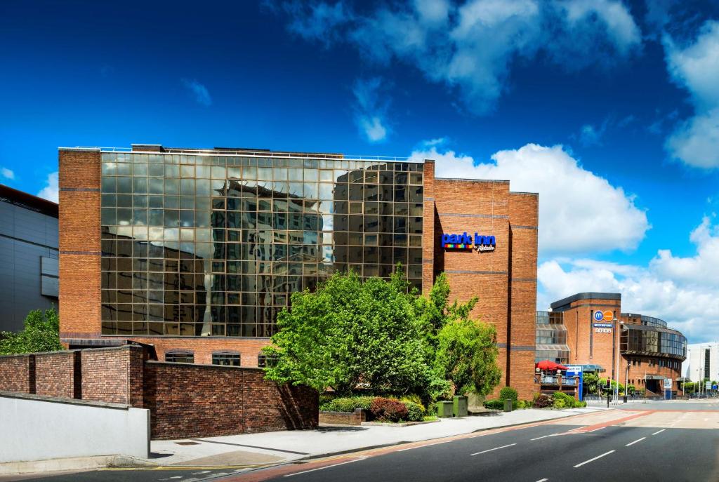 a large brick building on a city street at Park Inn by Radisson Cardiff City Centre in Cardiff