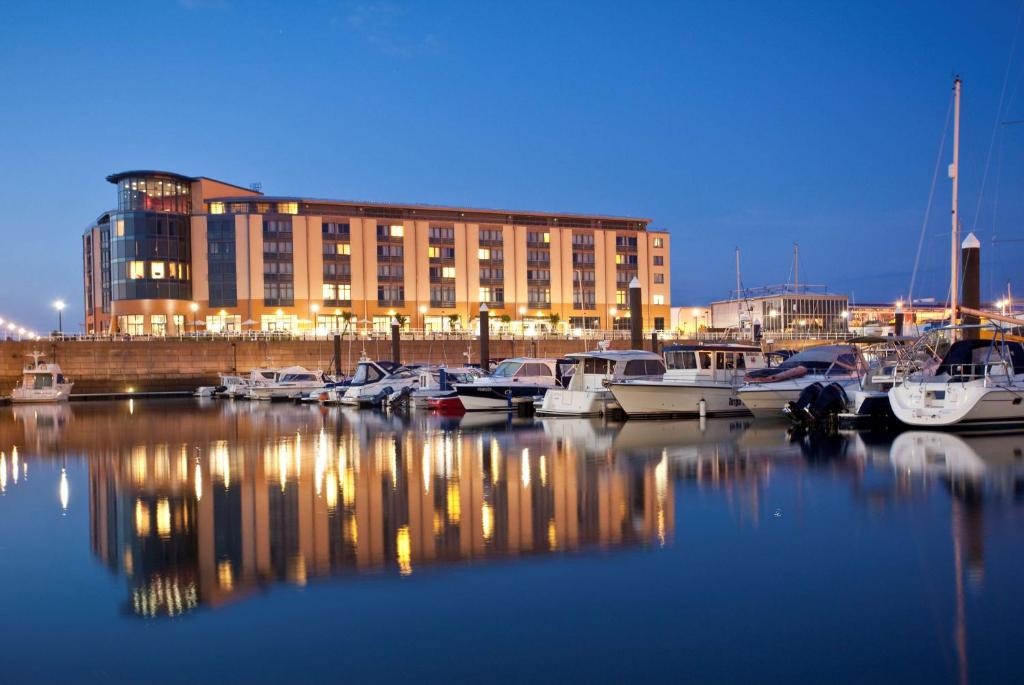 a group of boats docked in a marina at night at Radisson Blu Waterfront Hotel, Jersey in Saint Helier Jersey