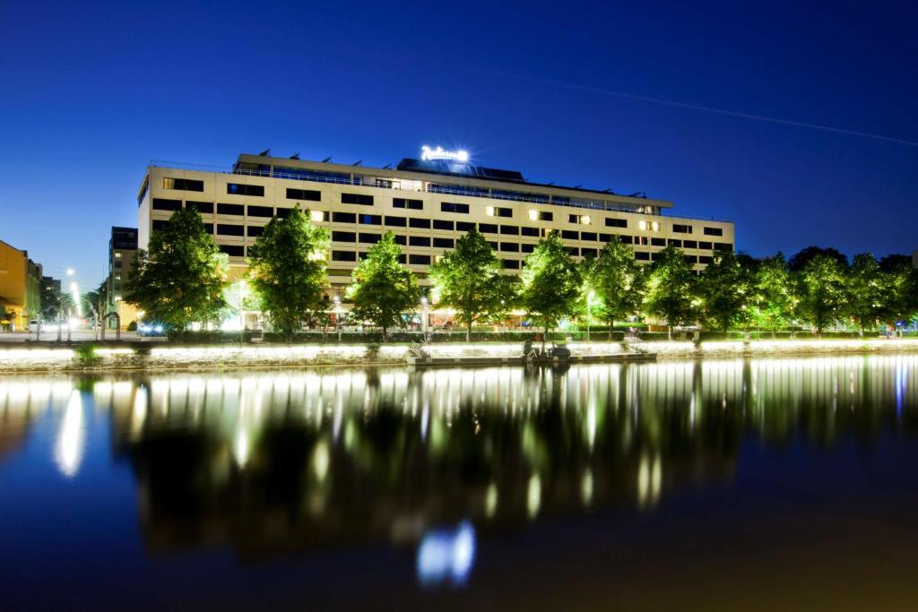 
a large building with a fountain in front of it at Radisson Blu Marina Palace Hotel, Turku in Turku

