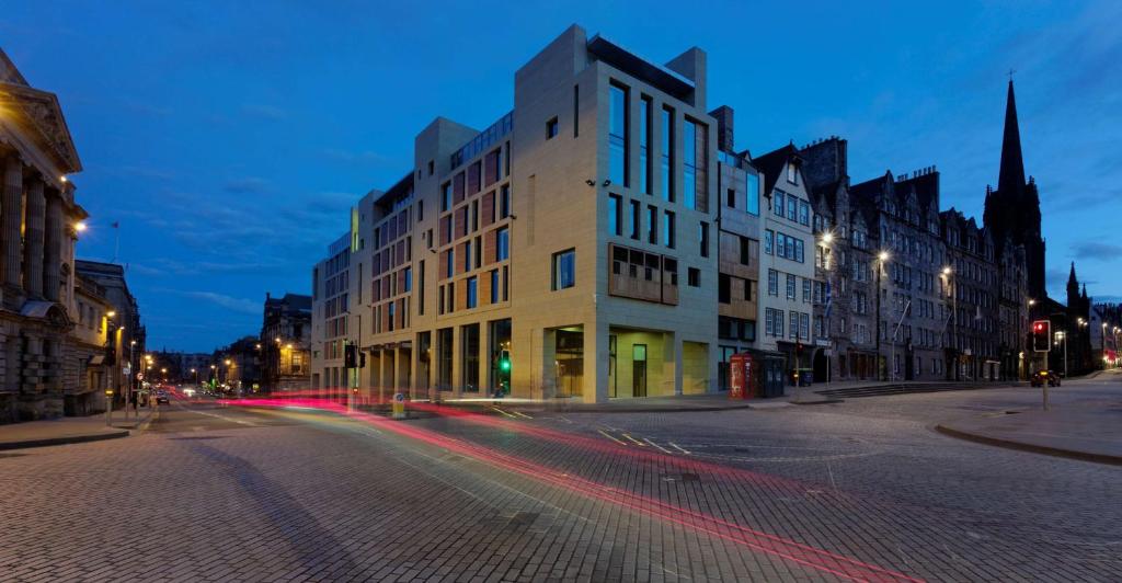 a city street at night with buildings and a church at Radisson Collection Hotel, Royal Mile Edinburgh in Edinburgh