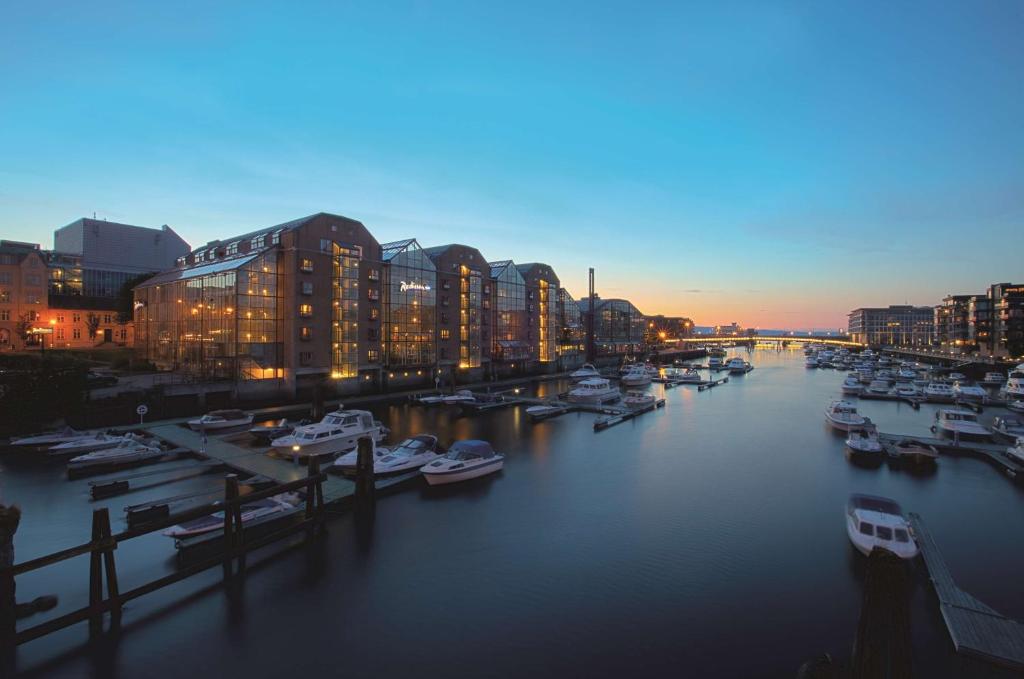 a group of boats docked in a marina at dusk at Radisson Blu Royal Garden Hotel, Trondheim in Trondheim