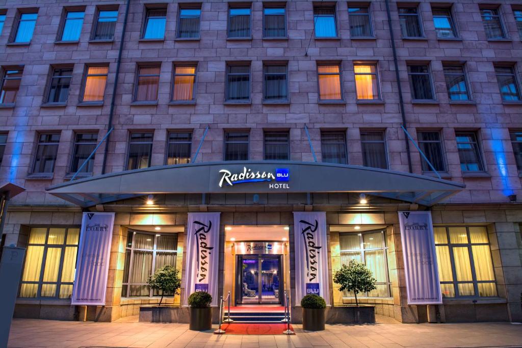 a hotel with a sign on the front of a building at Radisson Blu Hotel Bremen in Bremen