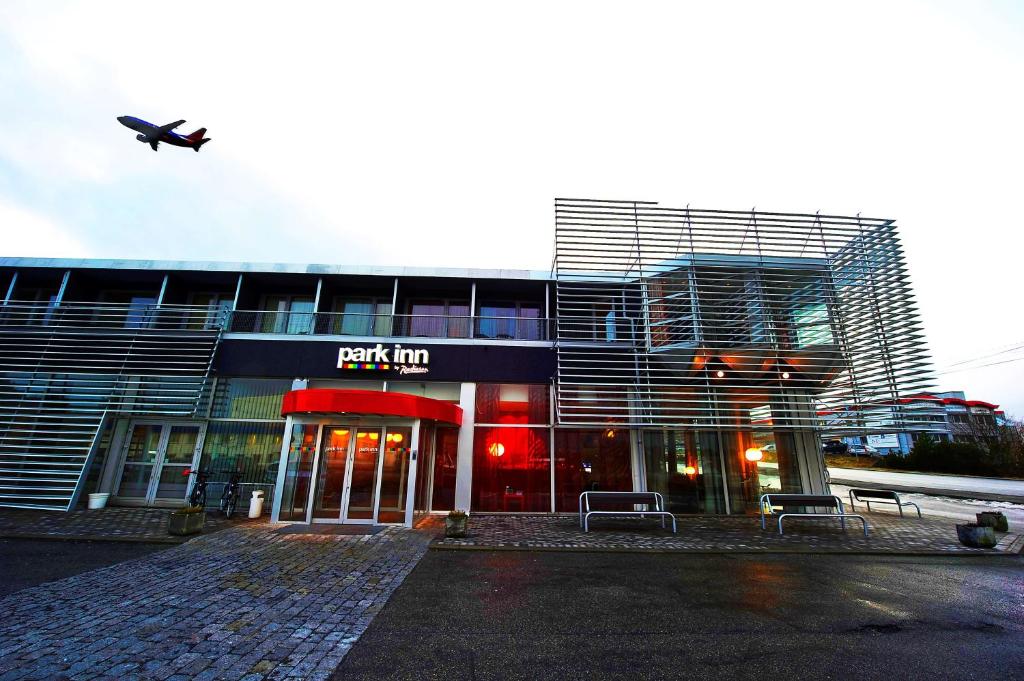 a parking lot in front of a building at Park Inn by Radisson Haugesund Airport in Avaldsnes