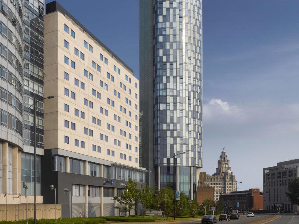 a tall building with a clock on it's side at Radisson Blu Hotel, Liverpool in Liverpool
