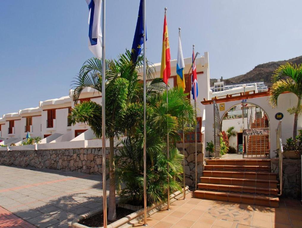 a group of flags in front of a building at Montecarlo Apartamento30 in Puerto Rico de Gran Canaria