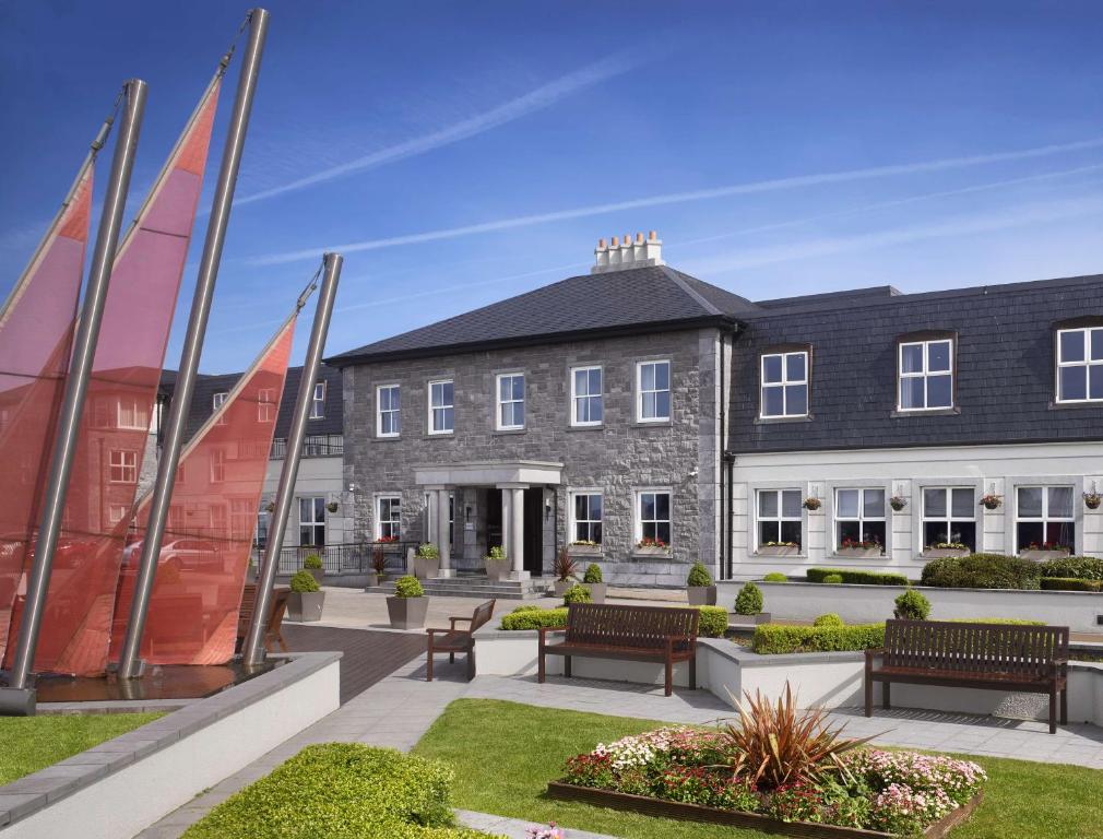 a building with benches in front of it at Radisson BLU Hotel & Spa, Sligo in Sligo