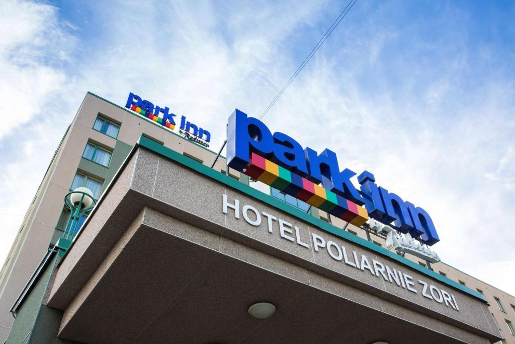 a blue and white building with a sign on it at Park Inn by Radisson Poliarnie Zori in Murmansk