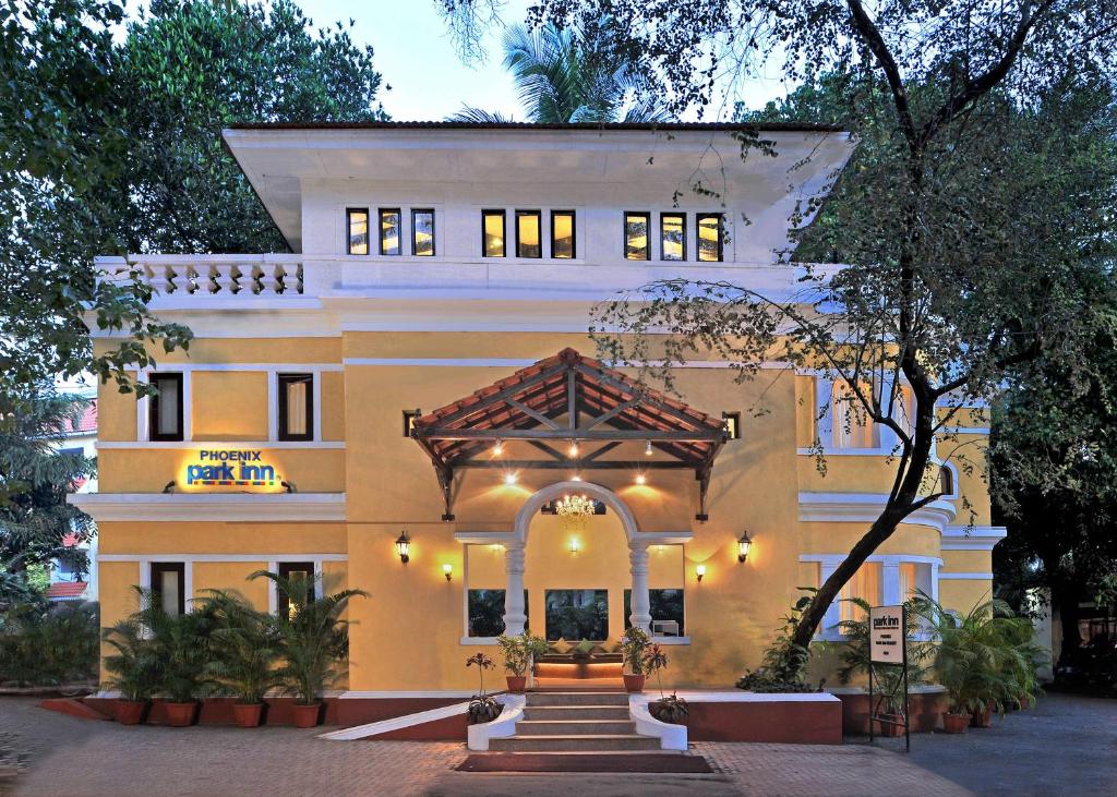 
a large building with a clock on the front of it at Park Inn by Radisson Goa Candolim in Candolim
