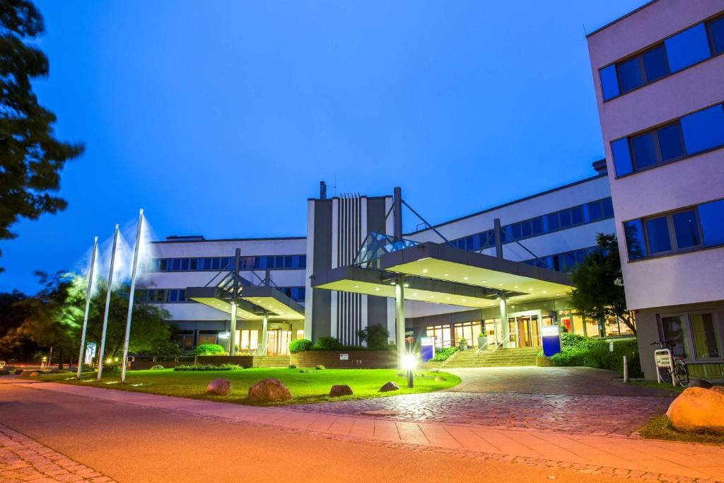 a large building in front of a building at Park Inn by Radisson Lübeck in Lübeck