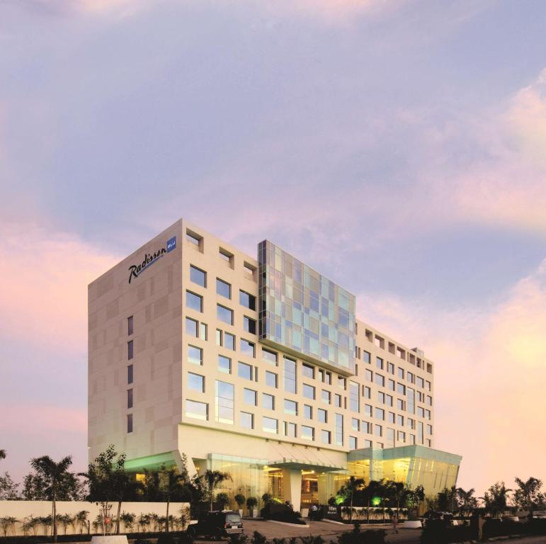 a rendering of a hotel with a building at Radisson Blu Hotel Pune Kharadi in Pune