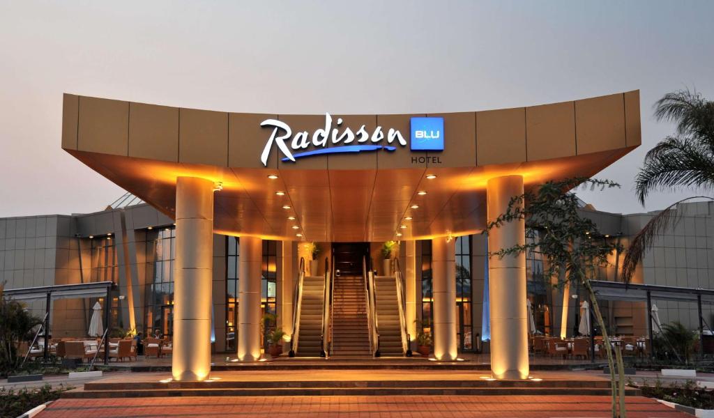a building with a sign on top of it at Radisson Blu Hotel Lusaka in Lusaka