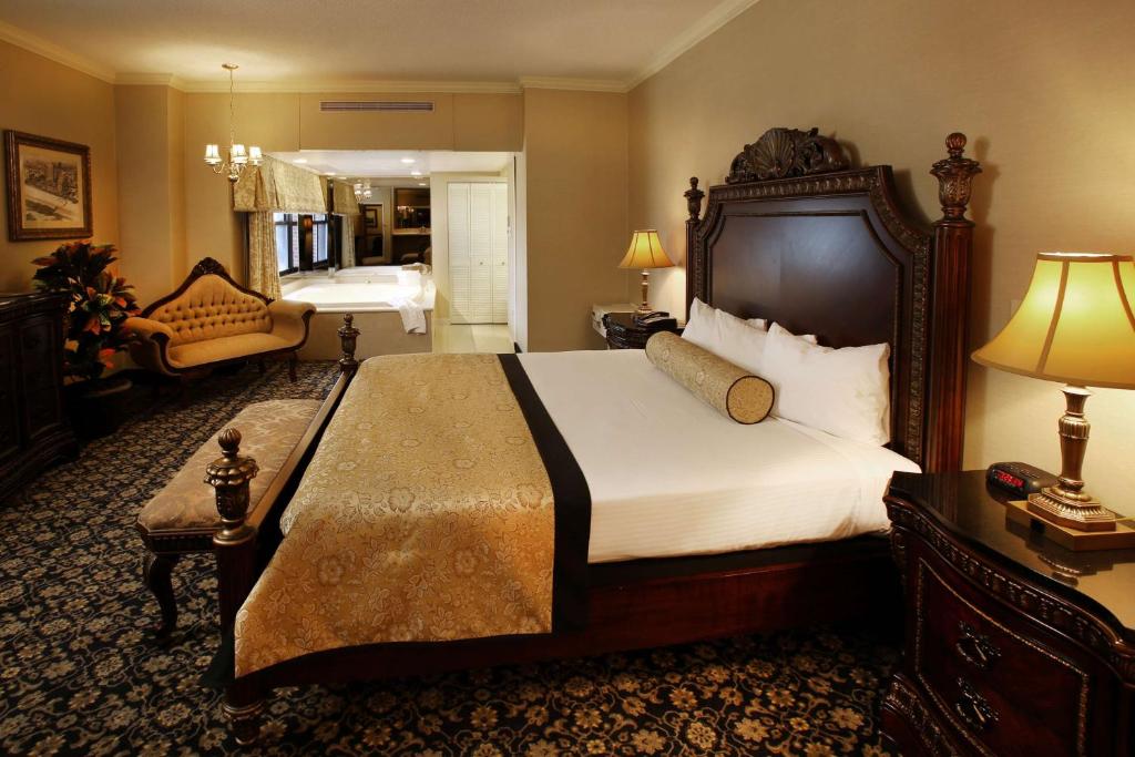 a bedroom with a large bed and a living room at The Claridge Hotel in Atlantic City
