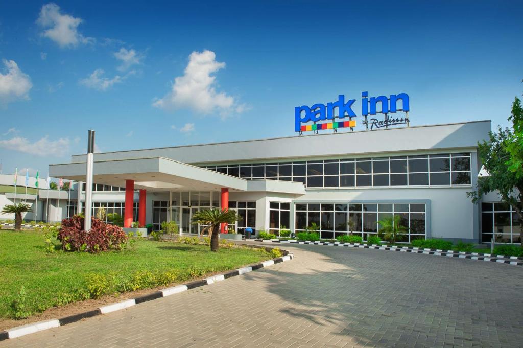 a park inn building with a parking lot in front of it at Park Inn by Radisson Abeokuta in Abeokuta