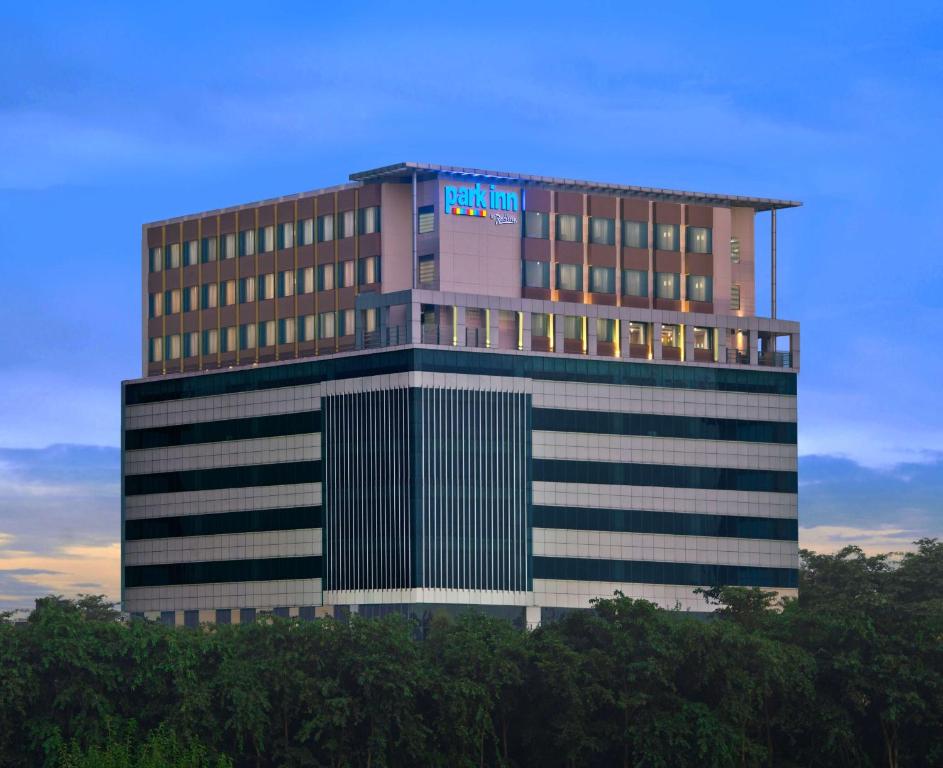 a tall building with a sign on top of it at Park Inn By Radisson Amritsar Airport in Amritsar