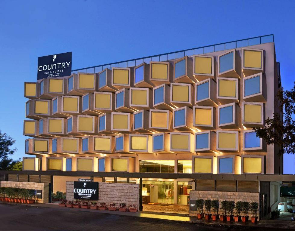 a rendering of a building with yellow windows at Country Inn & Suites By Radisson, Bengaluru Hebbal Road in Bangalore