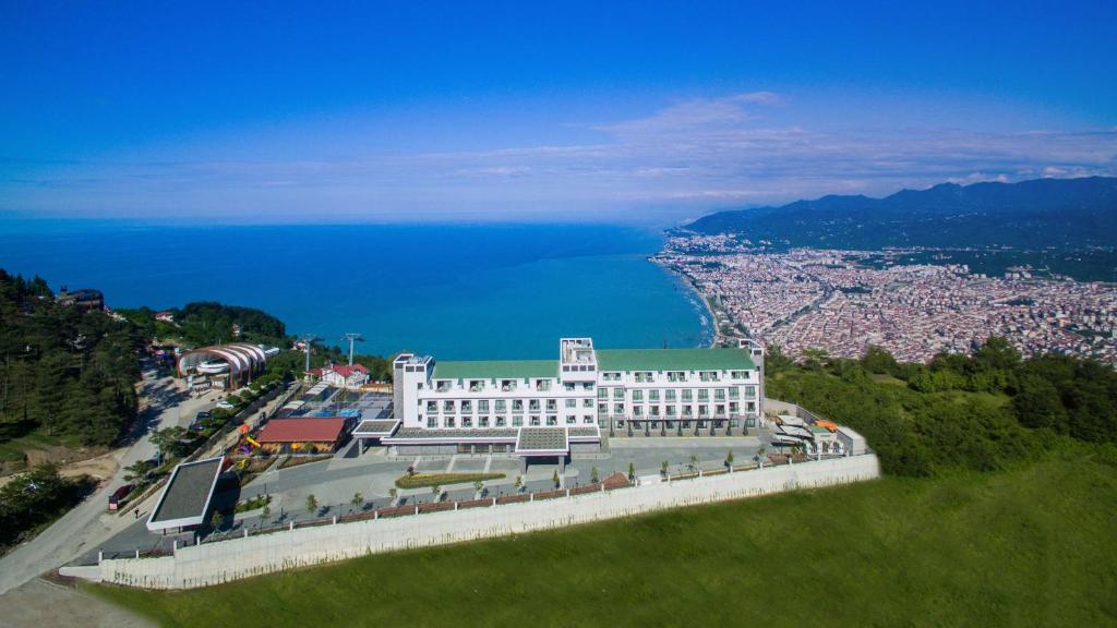 a building on a hill next to a body of water at Radisson Blu Hotel, Ordu in Ordu
