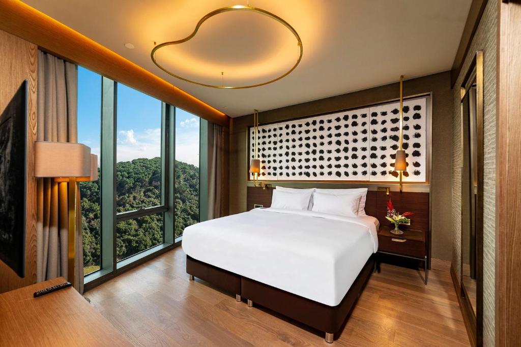 a bedroom with a white bed and a large window at Radisson Collection Hotel, Vadistanbul in Istanbul