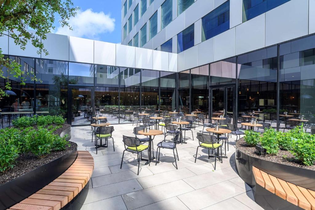 a patio with tables and chairs in front of a building at Park Inn by Radisson Antwerp Berchem in Antwerp