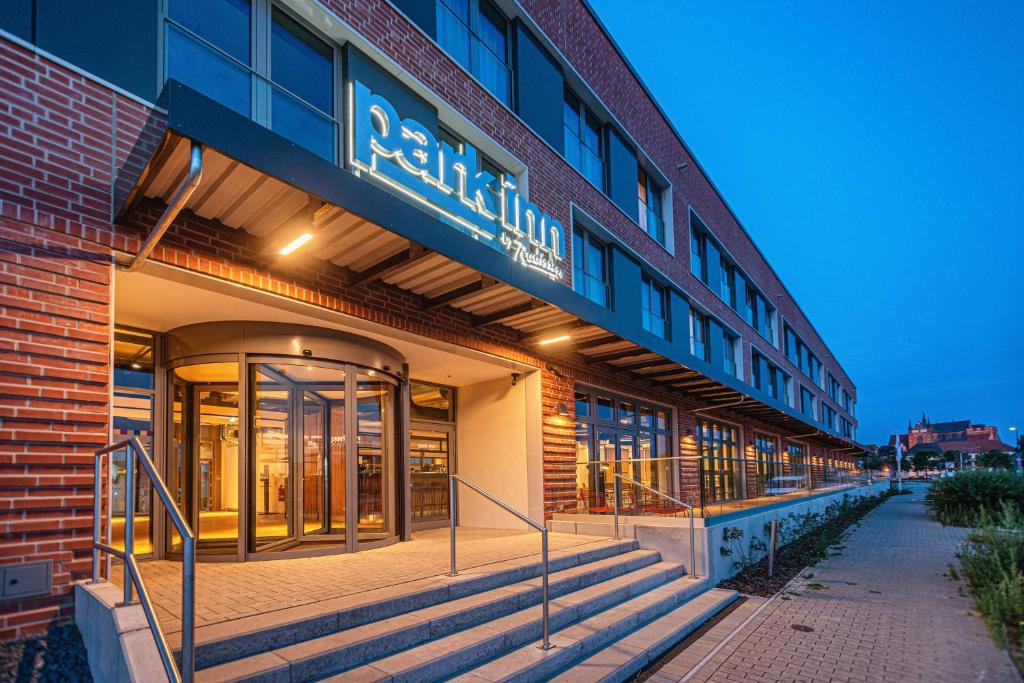 a building with a sign on the side of it at Park Inn By Radisson Wismar in Wismar