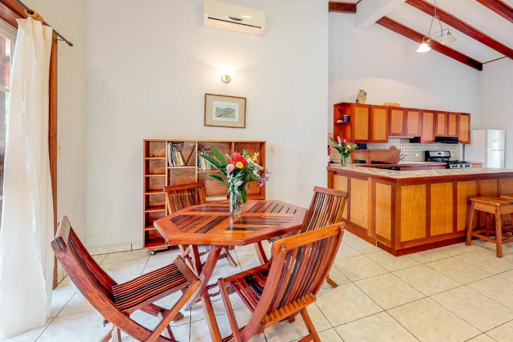 ein Esszimmer mit einem Tisch und Stühlen sowie eine Küche in der Unterkunft Framadani Villas in San Ignacio