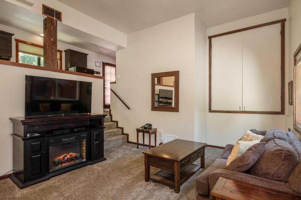 a living room with a couch and a fireplace at Yosemite Magic Studio "B" in Yosemite West