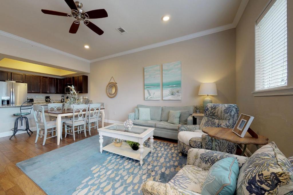 a living room with a couch and a table at Alerio Condos in Destin
