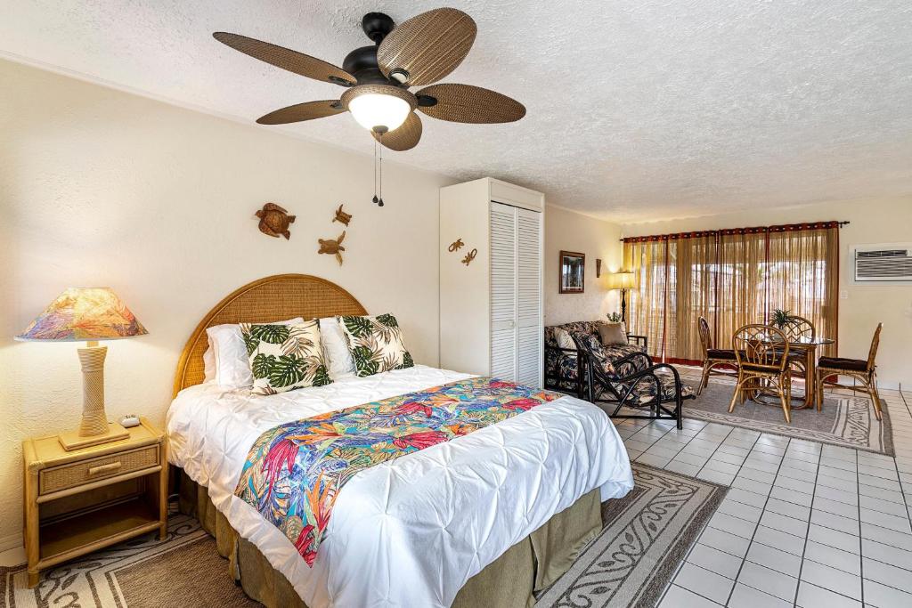 a bedroom with a bed and a ceiling fan at Kona Shores #203 in Kailua-Kona