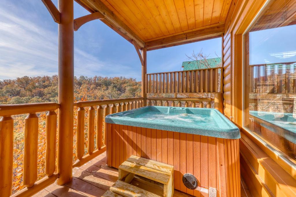 a hot tub on the deck of a cabin at Hillbilly Highrise in Pigeon Forge