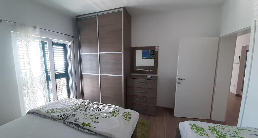 Postel nebo postele na pokoji v ubytování Apartments Villa Ravlić