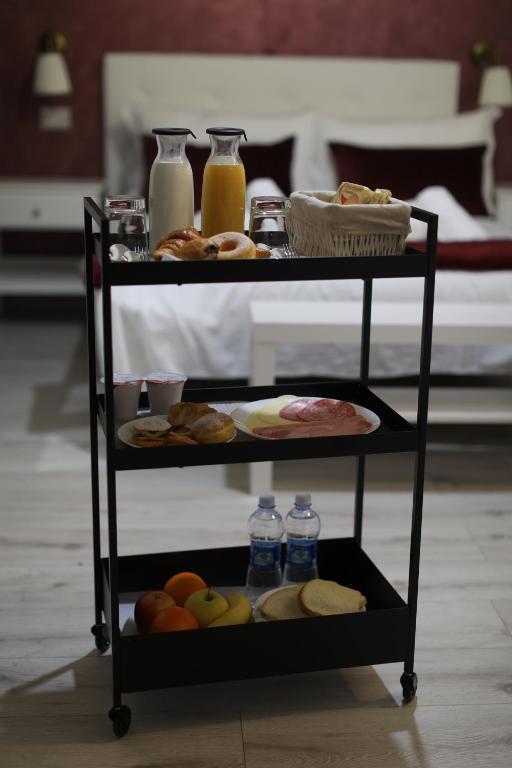 a shelf with food on it with bottles of water at Piccolo Hotel Boutique in Rome