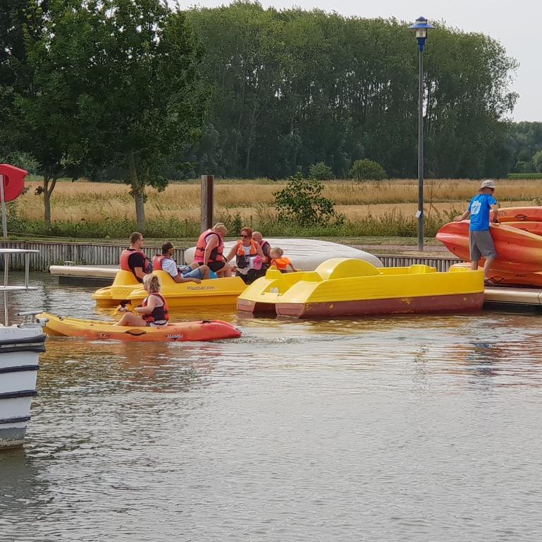 a group of people riding on boats in the water at LA POUDRIERE DE SAINT VENANT in Saint-Venant