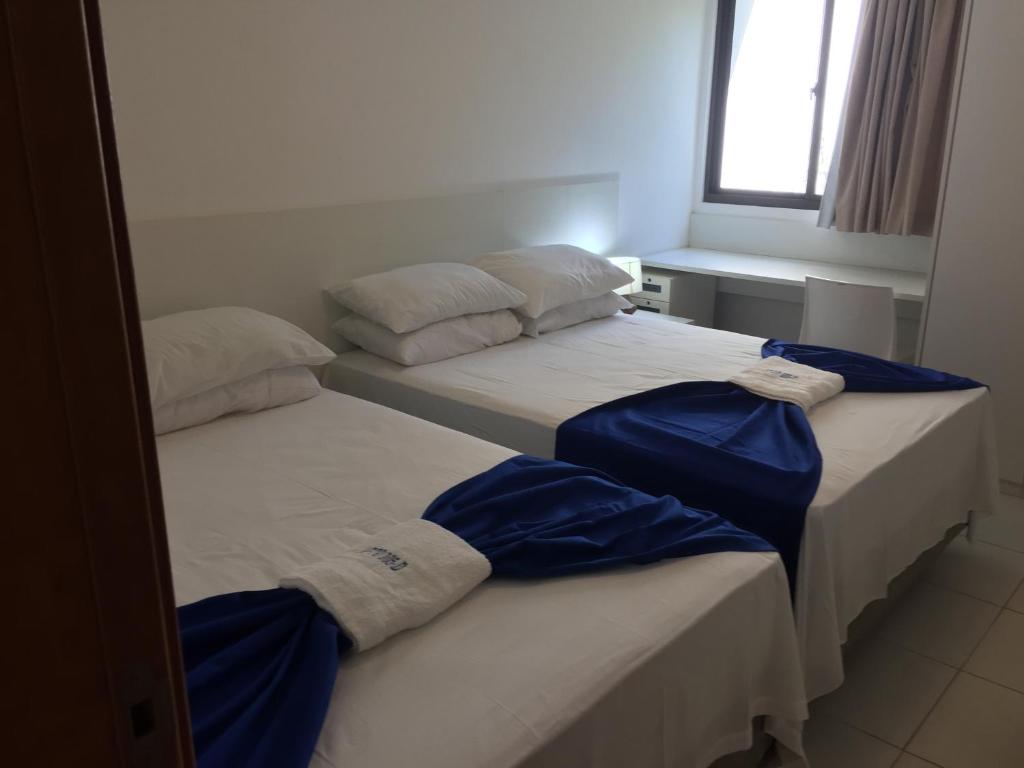 מיטה או מיטות בחדר ב-Carneiros Resort Beira Mar Térreo