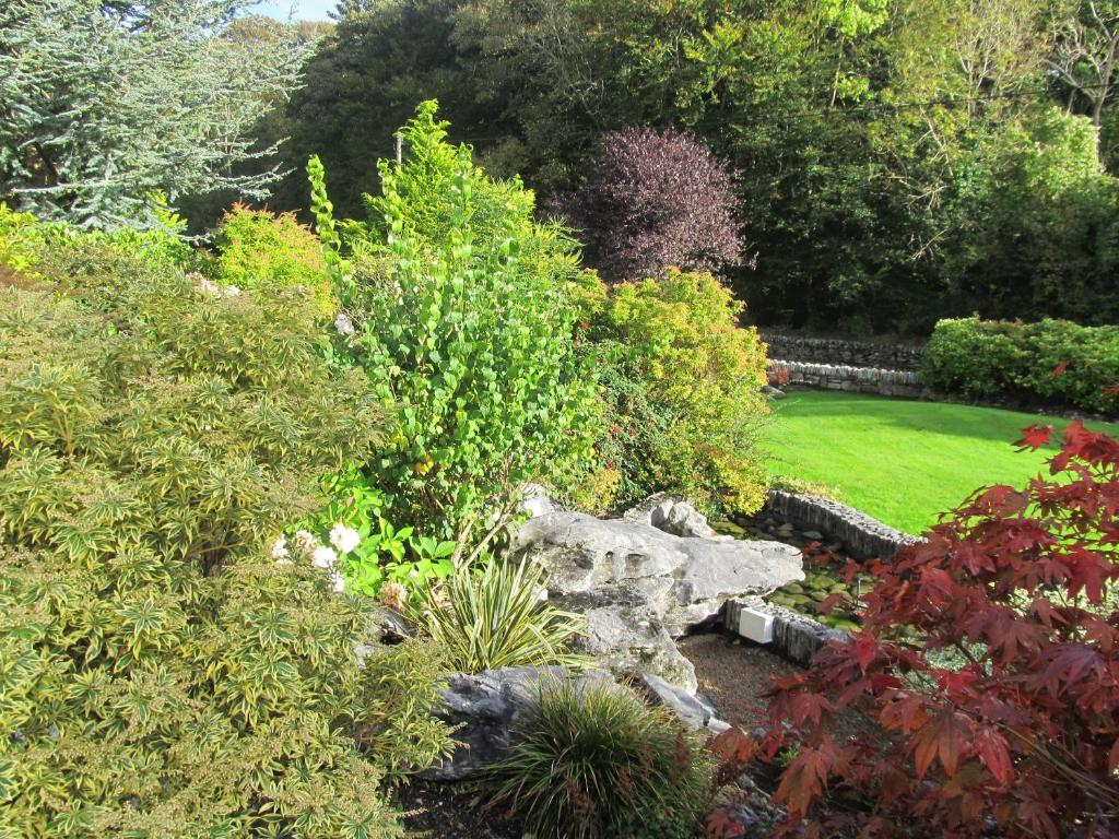 a garden with many plants and a lawn at Neidin House in Kenmare