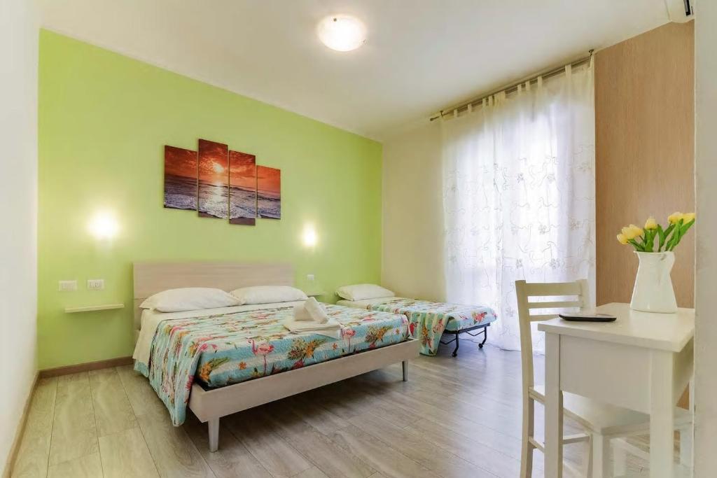 um quarto com uma cama, uma mesa e uma secretária em Leolù Guesthouse Alghero em Alghero