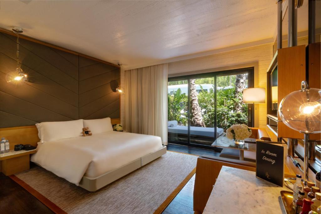 a bedroom with a bed and a large window at The Hollywood Roosevelt in Los Angeles