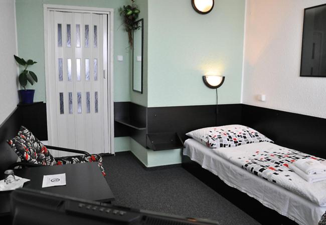 Postel nebo postele na pokoji v ubytování Hotel Milotel