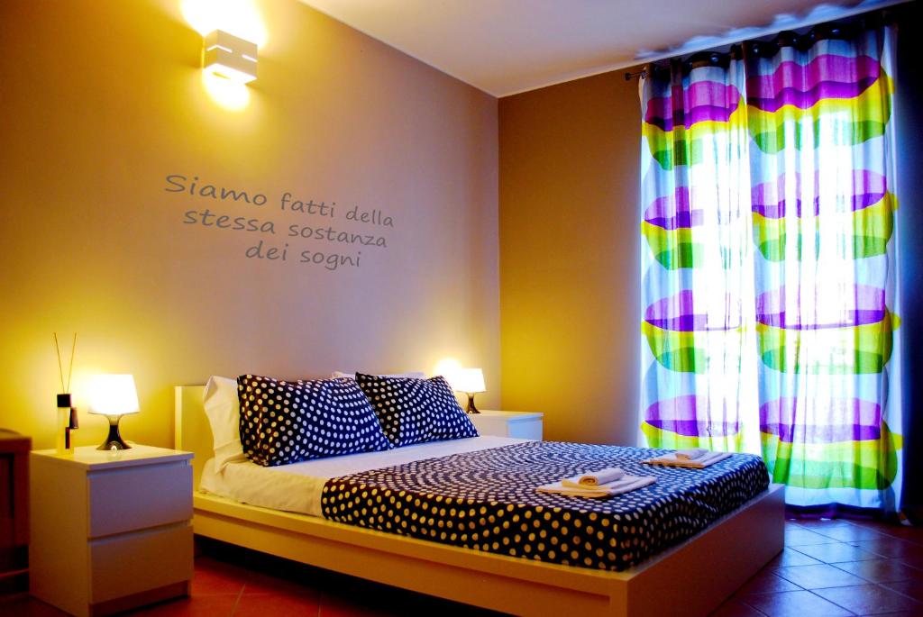 a bedroom with a bed with a sign on the wall at Bed And Breakfast Charming House in Barletta