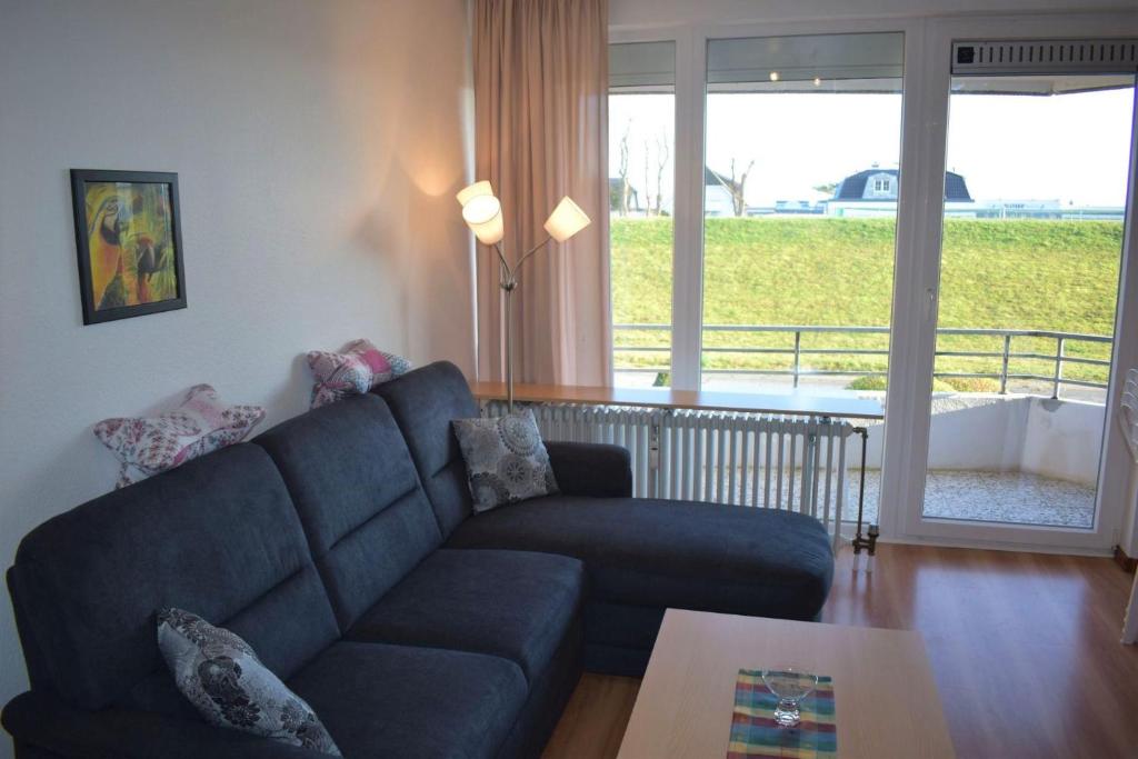a living room with a couch and a table at Haus am Deich Wohnung 5 in Dahme