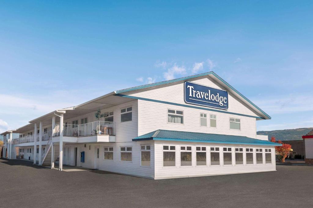 a large white building with a sign on it at Travelodge by Wyndham Salmon Arm BC in Salmon Arm