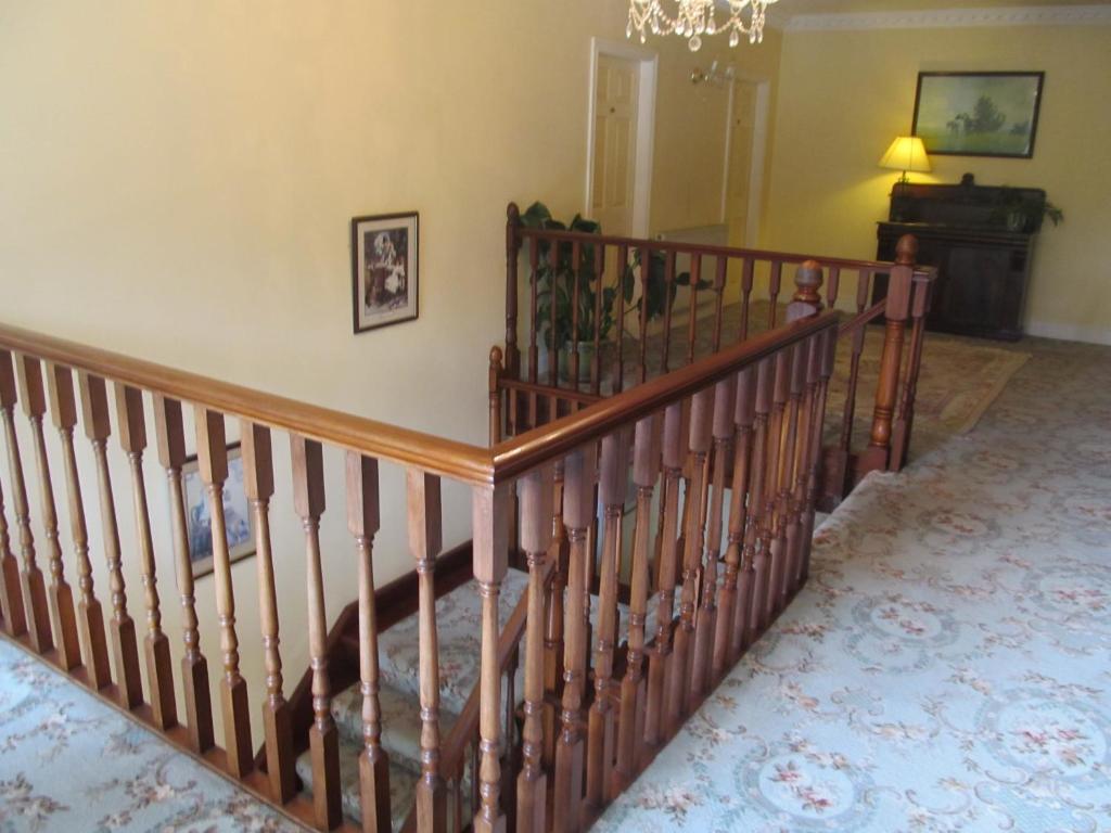 a wooden crib in a living room with a dog at Neidin House in Kenmare