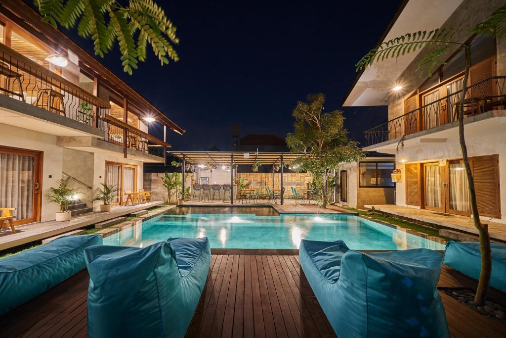 an image of a swimming pool in a house at night at Kubu Tropis in Ubud